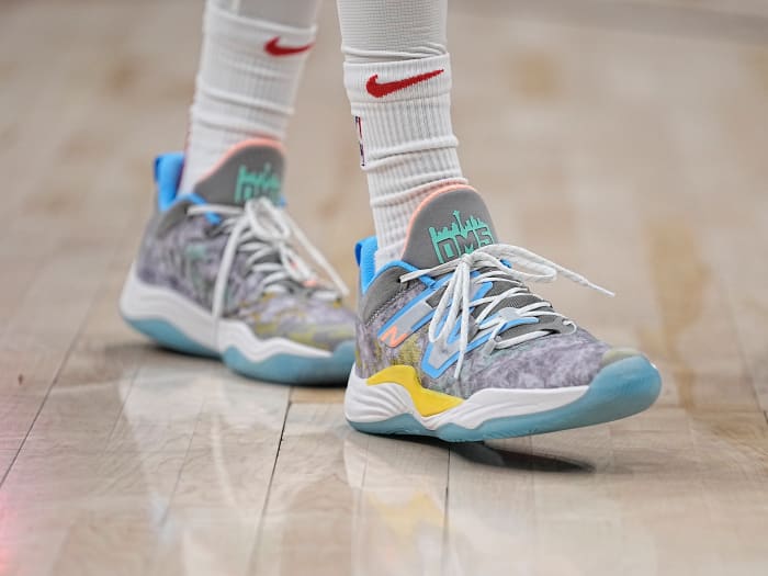 View of grey and blue New Balance shoes.